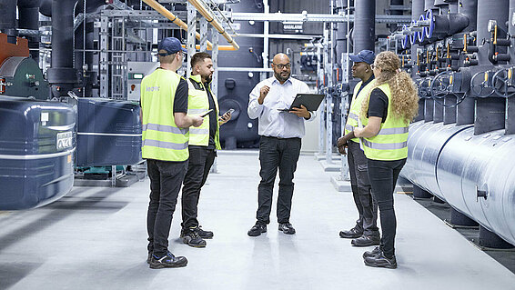 Leadec team talking at thermal power station.