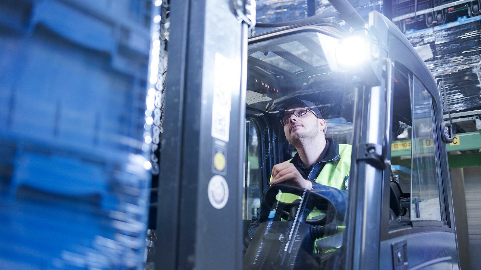 A close-up of a Leadec employee driving a forklift.